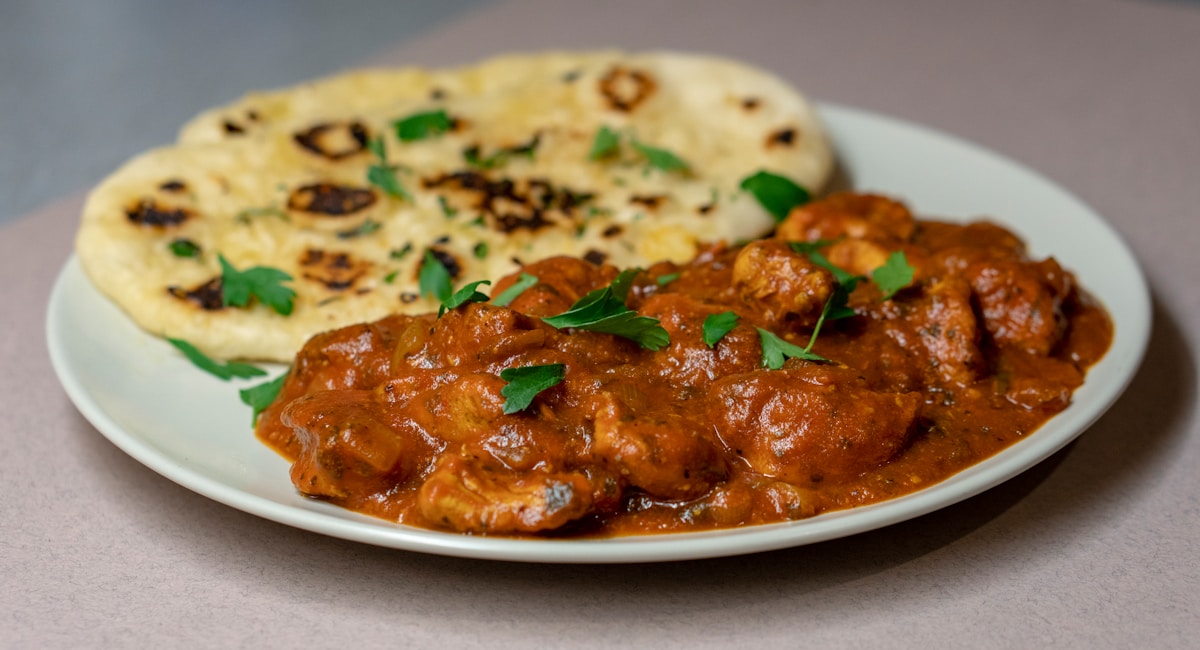 Roti canai flatbread with dhal and curry dipping sauce, Malaysian breakfast
